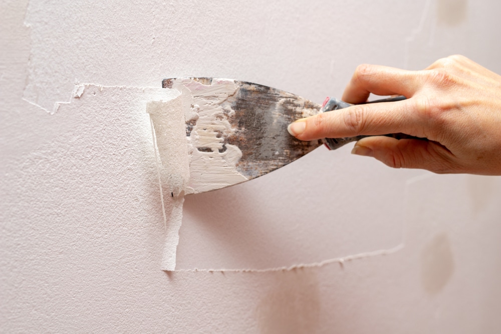 Stripping,Old,Paint,From,The,Wall.,Renovation,And,Painting,Of
